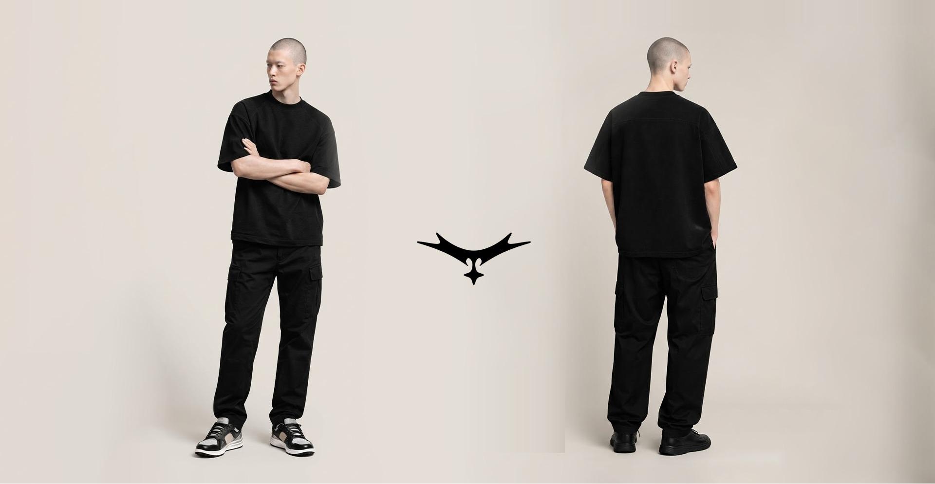 Two models wearing the Core Tee in Black Onyx in an oversized fit, one facing forward with arms crossed and one seen from the back